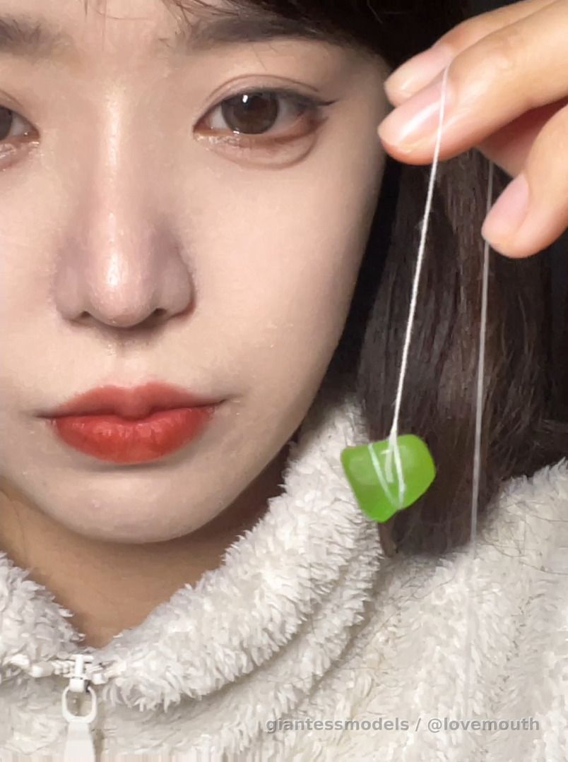 The girl swallowed a gummy candy, which caused her to gag and spit it out.
