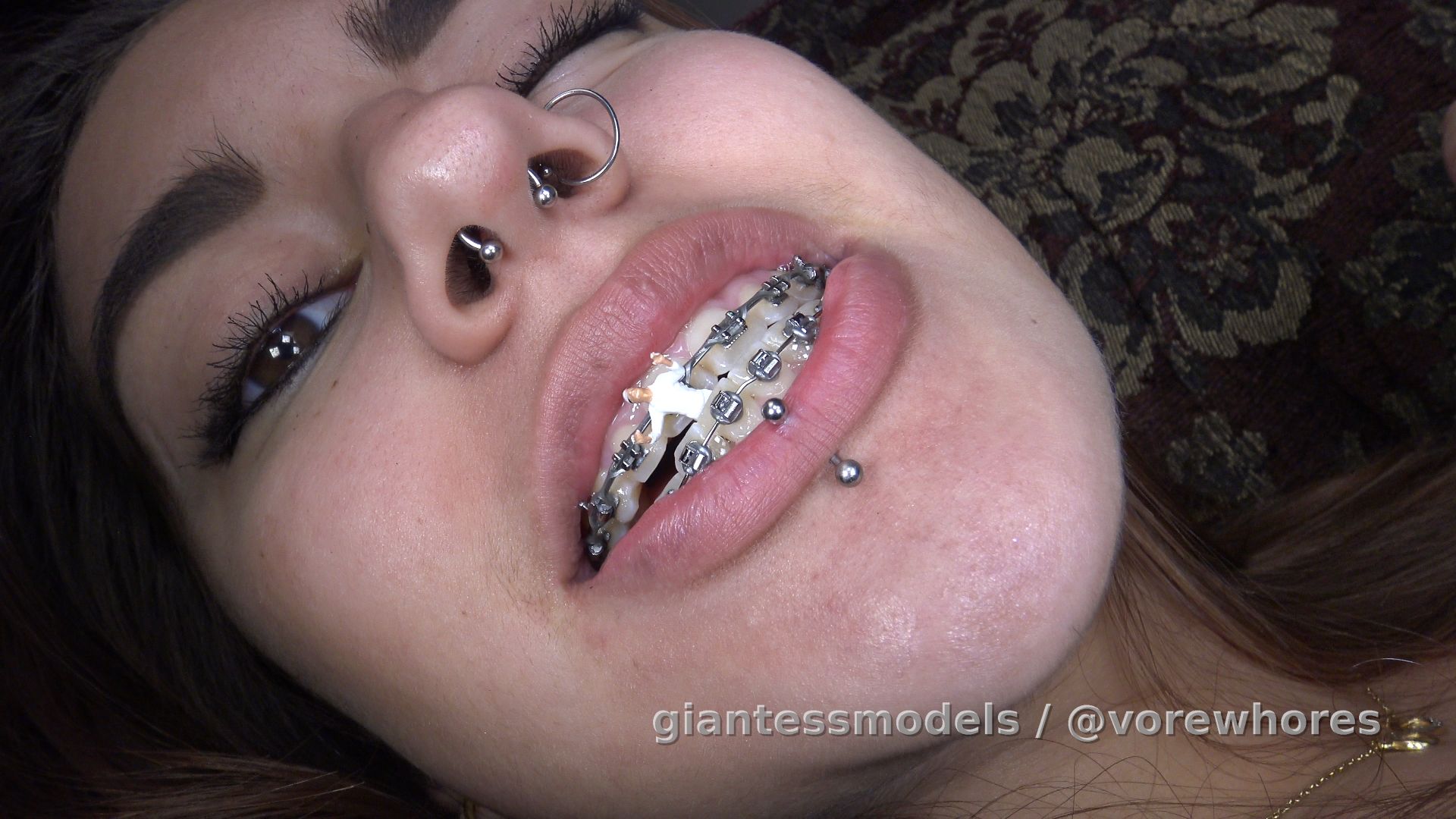 Video WV10S – Wink Swallows Her Orthodontist – Wink is tired of opening wide so the Dentist can stick his fat fingers in her mouth. She is very annoyed and thinks that if the dentist wants to get in there so bad, maybe she should help him. She shrinks him and takes him home for some up-close inside mouth probing and prodding.
