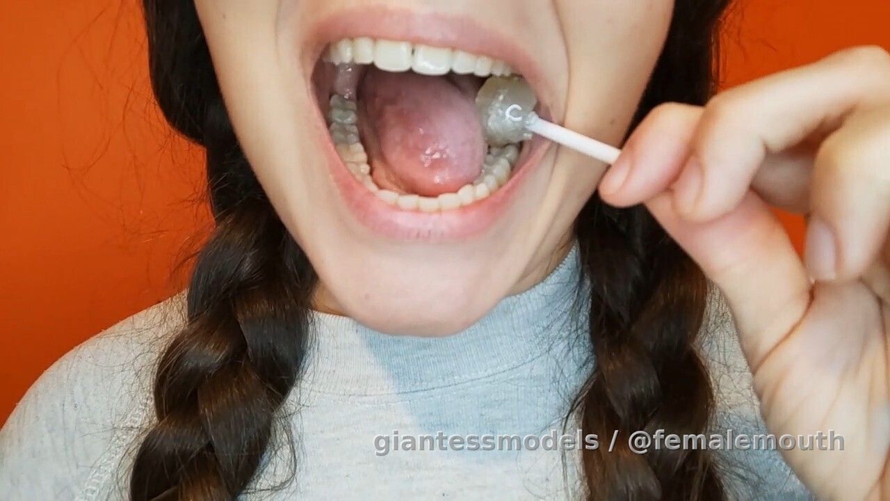 Lollipop crushed in a sexy mouth! The edges and pure geometry of her molars is way more superior!