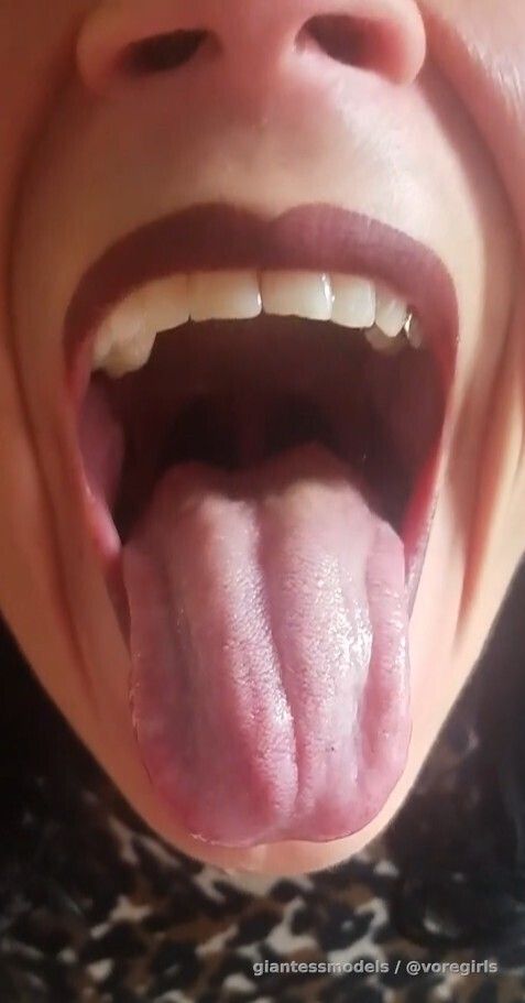 Crazy black haired woman swallows 2 worms and 2 fish after her meal. 