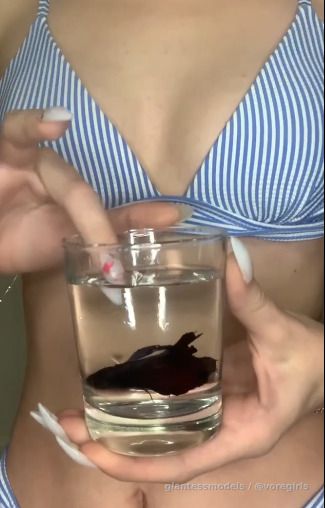 Hot Blonde Russian Girl swallows a fish and belly dances. 