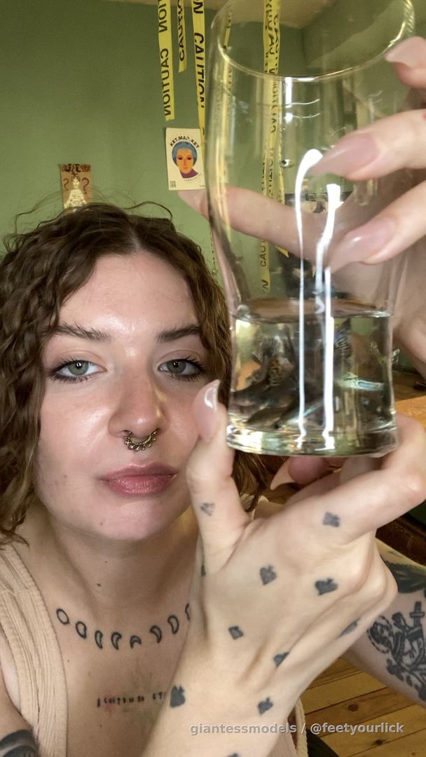 Drinking full glass of water with 20 fish in it 
