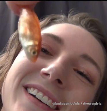Brunette Baddie gulps down a Fish, Burps and smokes while digesting.