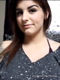 Cute Brunnette swallows some fish and digests them. 