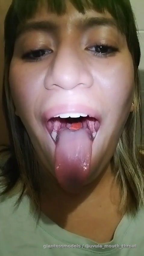 Cute colombian girl gulping fruit