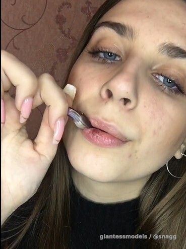 Brunette gulps down small fish