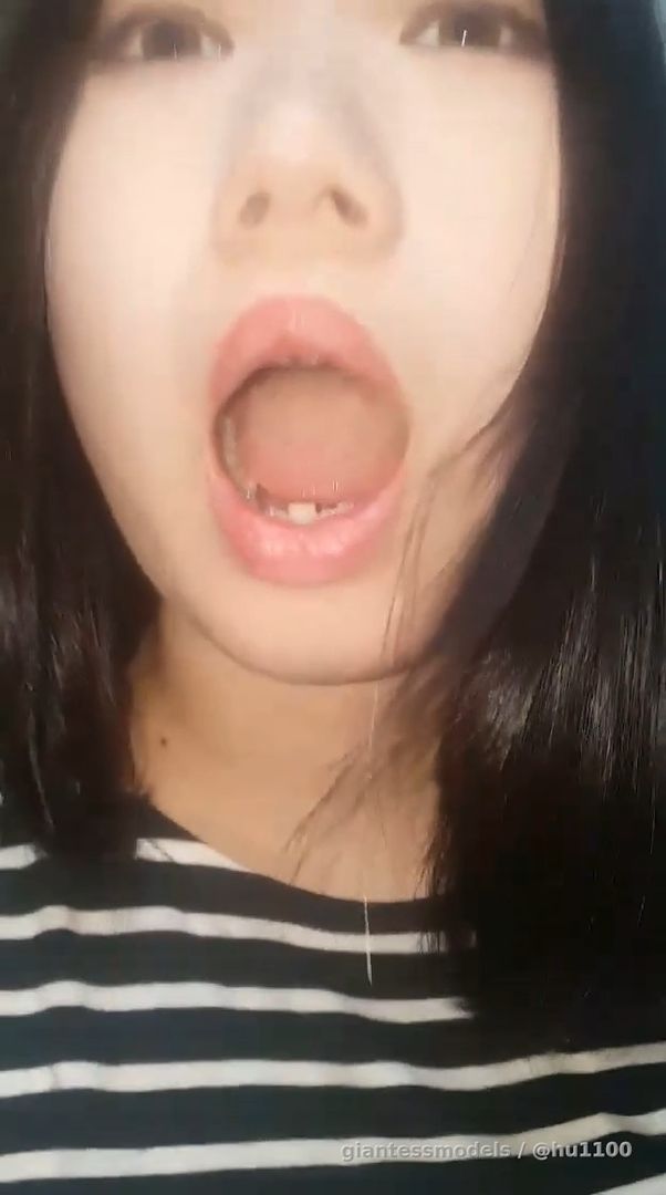 A Korean girl vomits while showing the inside of her mouth