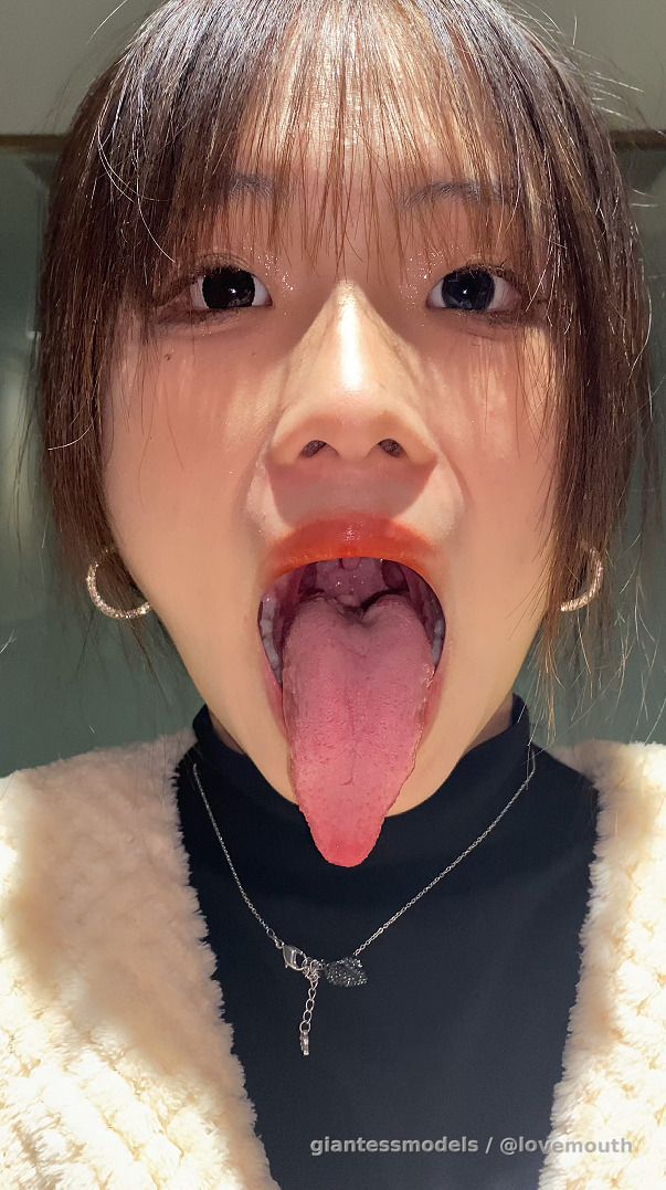 Girl shows her mouth and swallows gummy candy