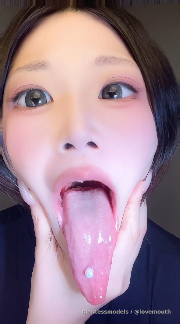The mouth of a girl with a long tongue