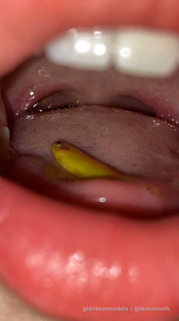 The girl swallowed the small fish, then spat it out.